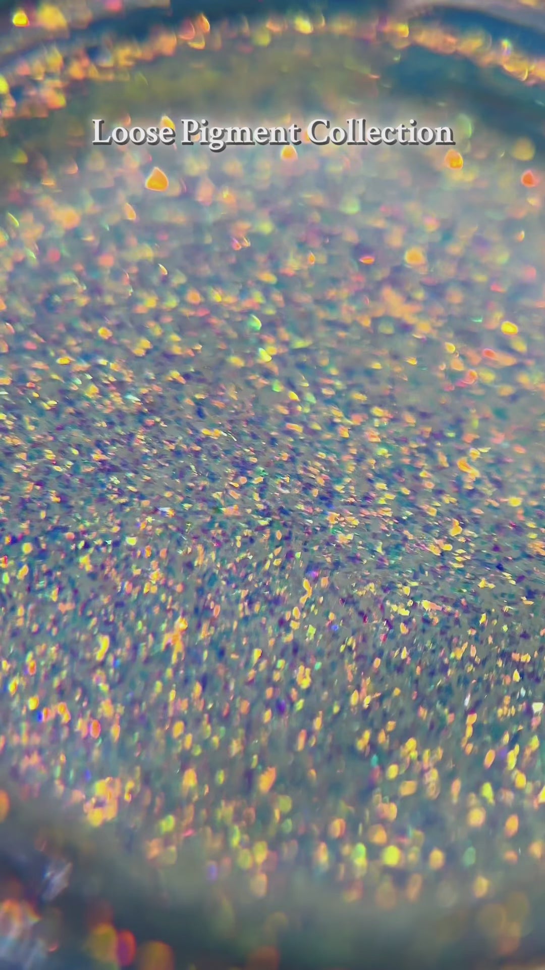 Vibrant loose pigment collection featuring multi-colored holographic particles for dazzling makeup looks.