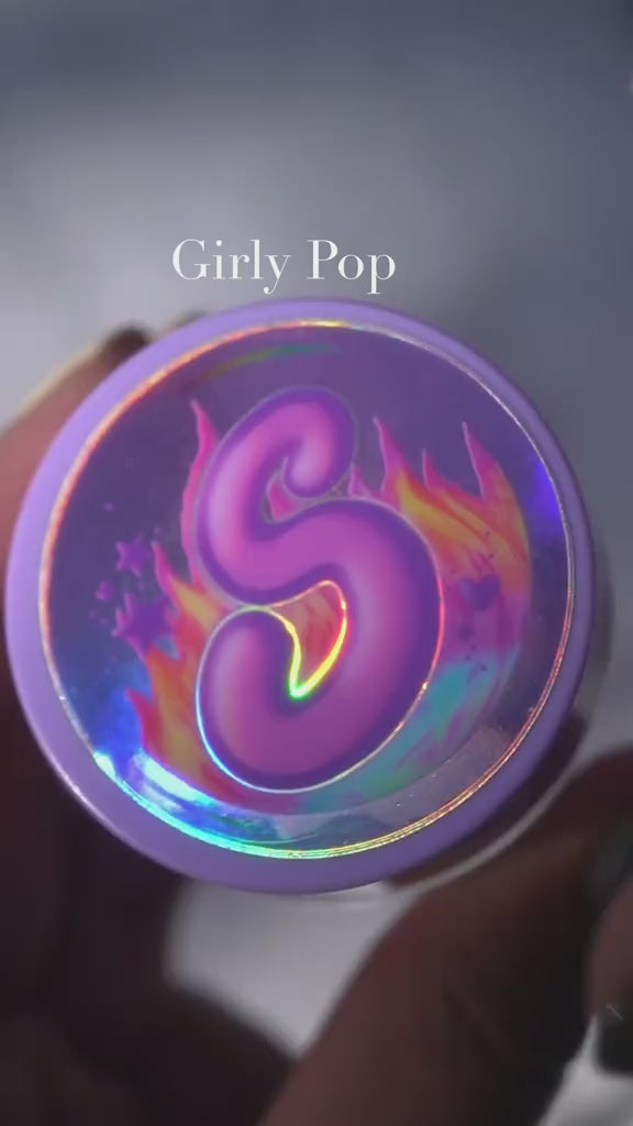 Girly Pop holographic cosmetic container featuring a vibrant purple 'S' design.